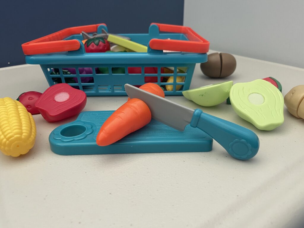 A velcro cuttable vegetable toy on a table.